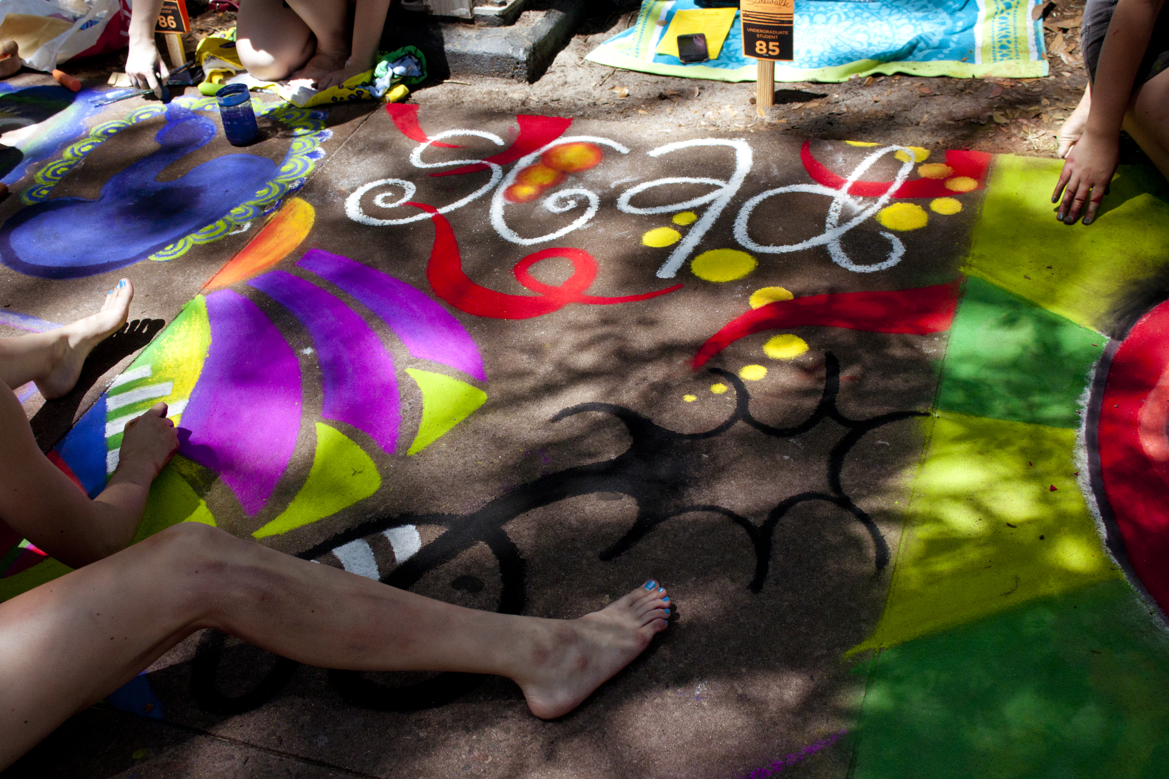 Participants working on their sidewalk chalk artwork