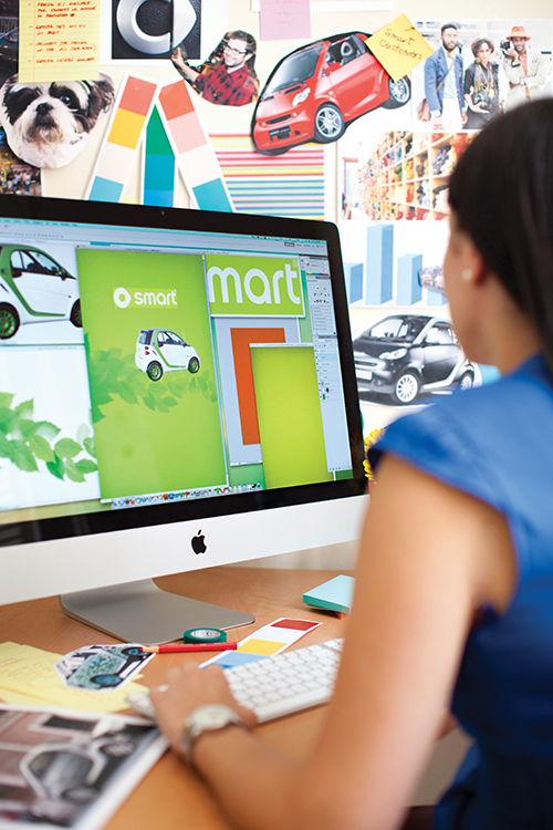 Woman designing an advertisement on a computer