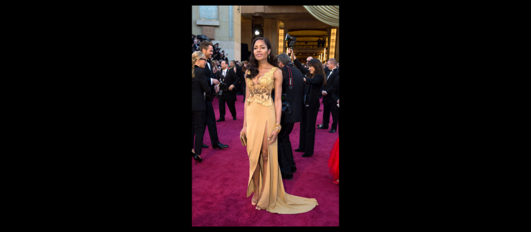 British actress and Bond Girl Naomie Harris wears a dress designed by SCAD Atlanta fashion student Michael Badger on the Oscar red carpet