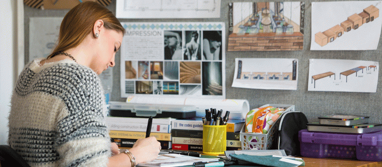 Student works at a desk