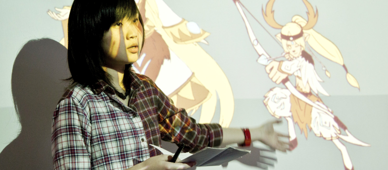 Student presenting work projected on screen