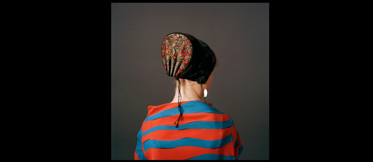 Photograph of back of woman wearing danish bonnet
