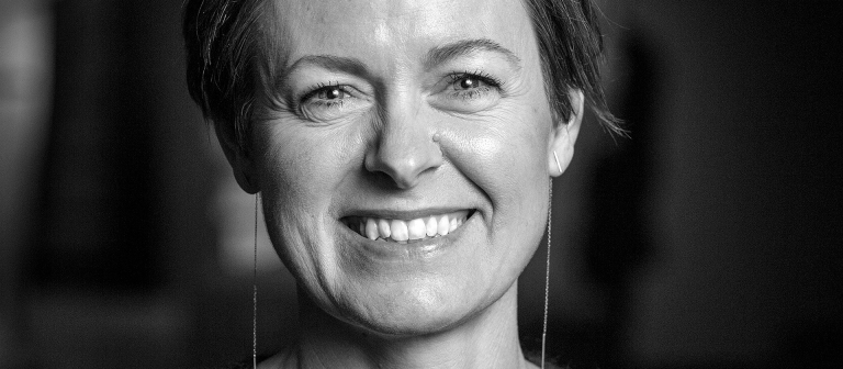 black and white portrait of Trine Sondergaard smiling