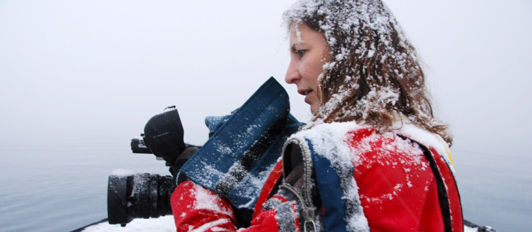 Janet Biggs in snow with camera