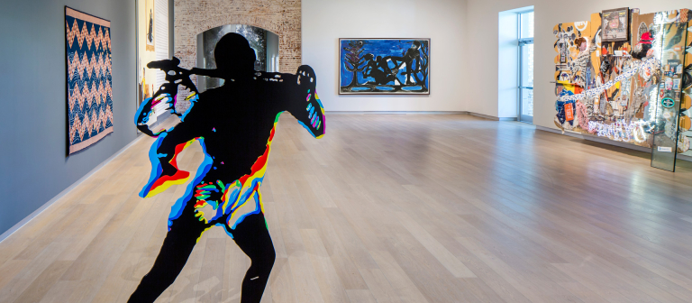 Fuzzy graphic outline of person standing actively within an art gallery