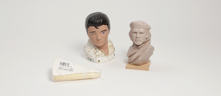 Miniature busts of Elvis Presley and Che Guevara with a slice of Brie