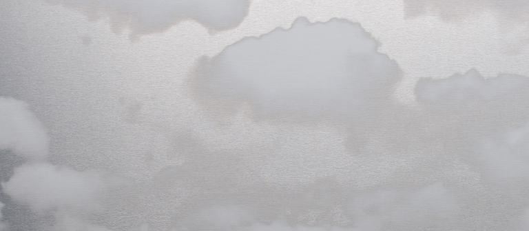 White clouds float against a steely gray background