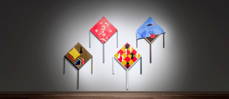 Four wood panels spotlighted on empty gallery wall