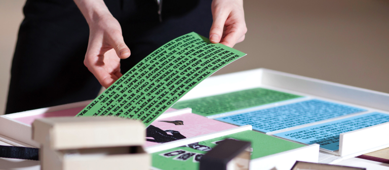 Examining artist's books on display at symposium
