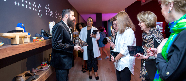 Visitors attending SCAD FASH Shoes exhibition reception