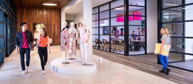 Fashion students walking through lobby of Number Nine