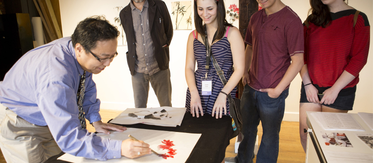 A SCAD professor demonstrates a painting technique during SCAD Day