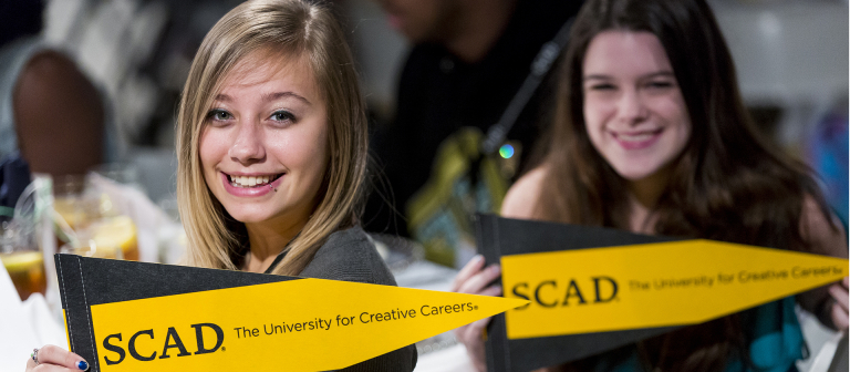 SCAD students with pennants