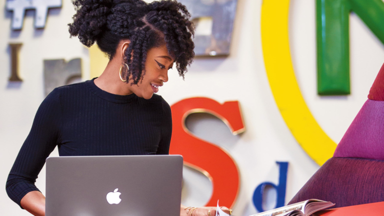 Atlanta advertising student at work on laptop