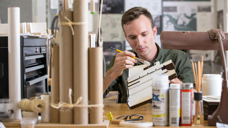Architecture student building model in Eichberg Hall studio
