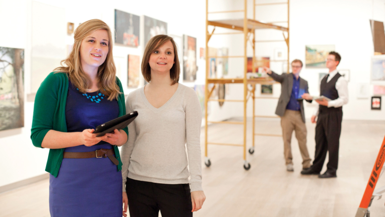 Business Design and Arts Leadership students installing exhibit