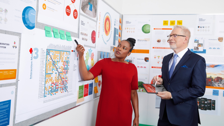 Design management student and professor review a project