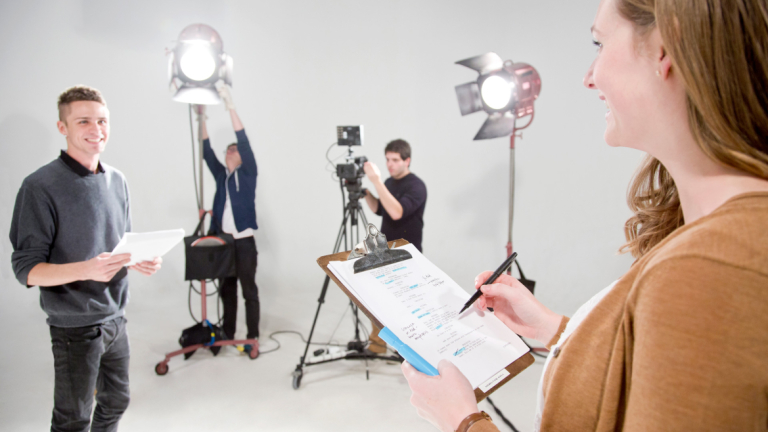 Dramatic writing student reviewing script on set