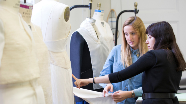 Fashion designer Benhaz Sarafpour mentoring student Fashion mentor Benhaz Sarafpour critiquing garment with student