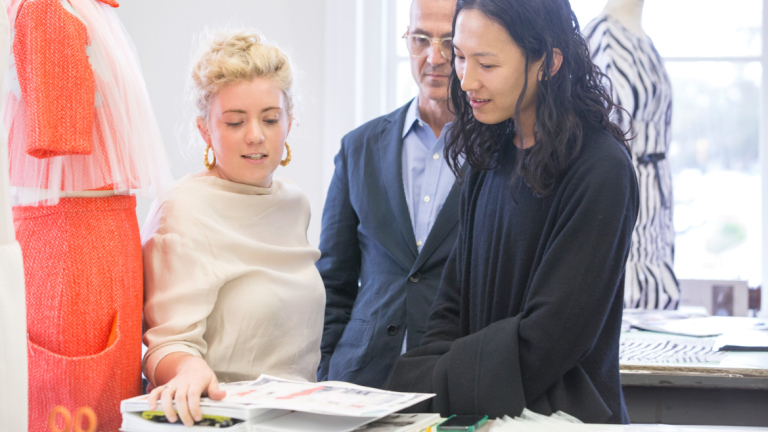Steven Kolb and Alexander Wang reviewing fashion student work
