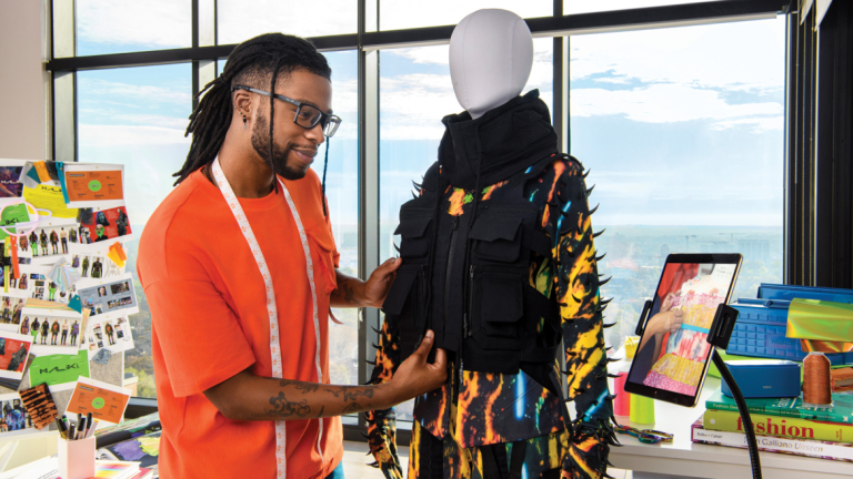SCADnow student working on fashion piece while using online tutorials.