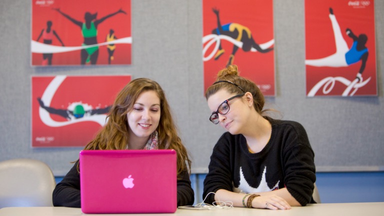 SCAD students collaborating on project SCAD students using laptop to collaborate on project
