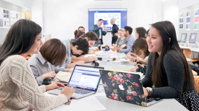 SCAD graphic design students working together in classroom