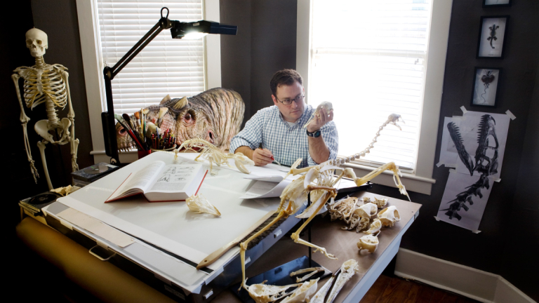 Scientific illustration student sketching a specimen in studio