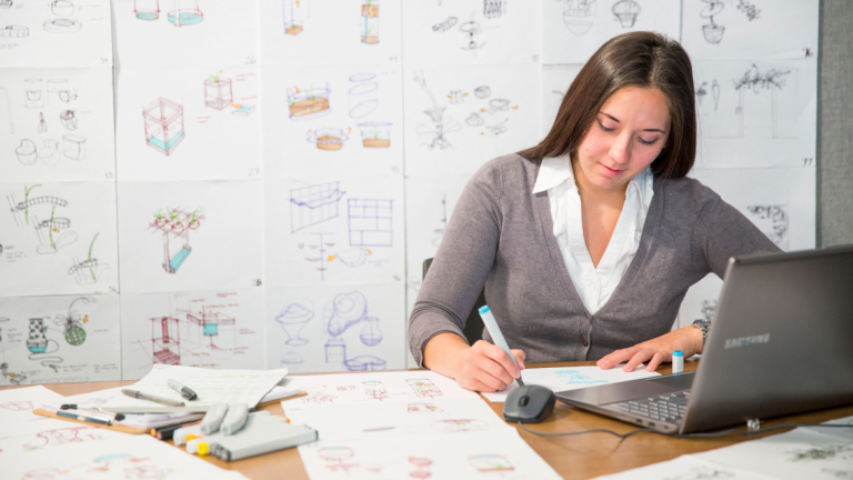 Industrial design student sketching designs in studio