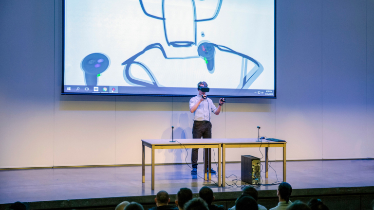 Industrial design alumni demonstrates 3D prototyping to students