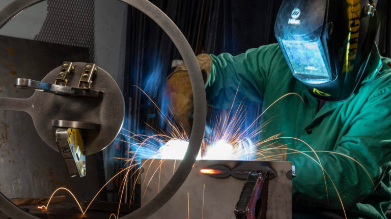 Industrial design student Andrea Parziale welding