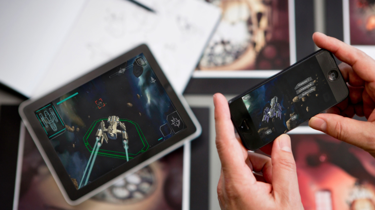 SCAD student demonstrating mobile game SCAD student gaming on mobile phone and tablet