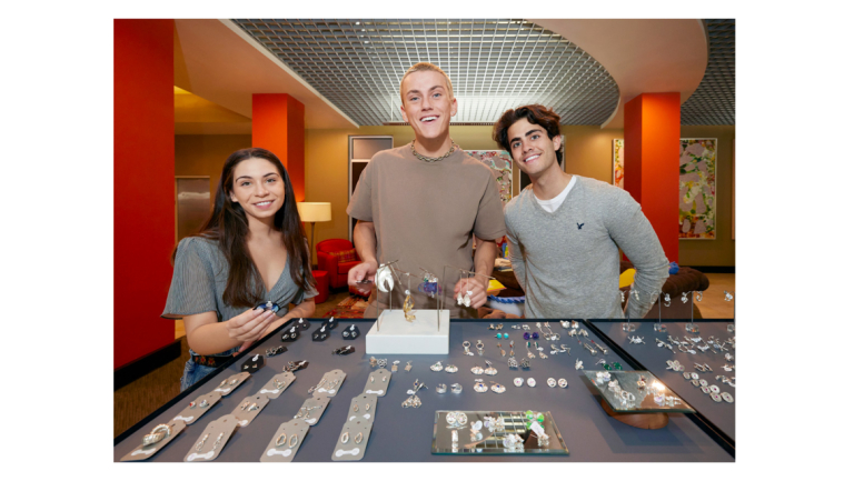 students showing a display of jewelry