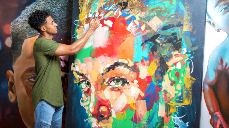 SCAD alumnus Jon Moody painting a canvas