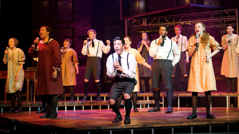 Performing arts students singing in Spring Awakening Performing arts students singing on stage Spring Awakening