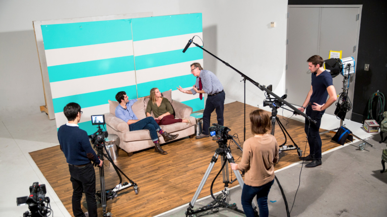 Performing arts students learning to act on film and televising set