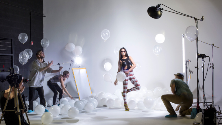 Photography student shooting fashion SCAD students working on set of fashion photo shoot