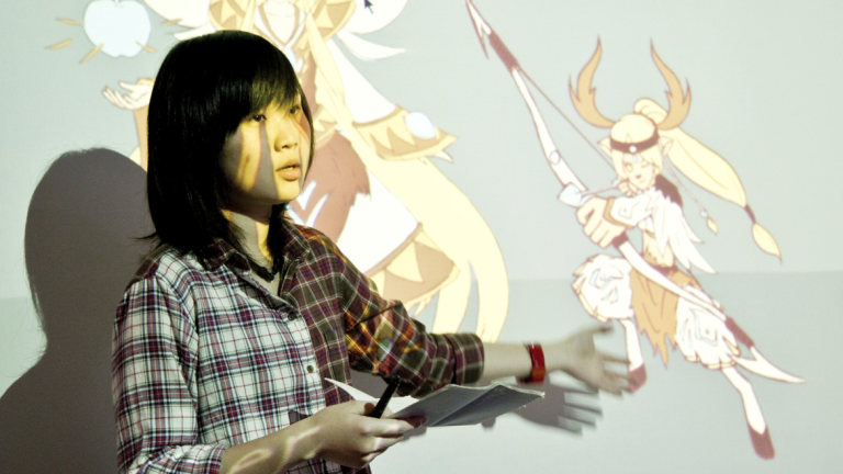 Student presenting work projected on screen