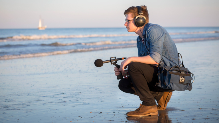 Sound design student making field recordings SCAD student using field recording equipment to capture beach sounds