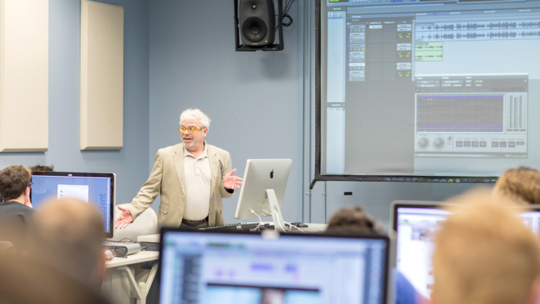 LeGrand lectures in the front of a computer lab