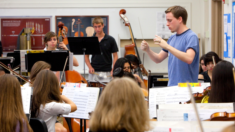 SCAD student conducting a musical ensemble