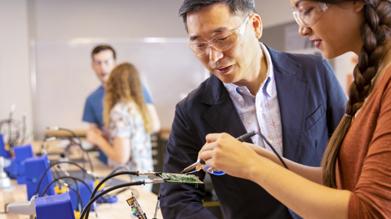 User experience design student and professor work on a prototype