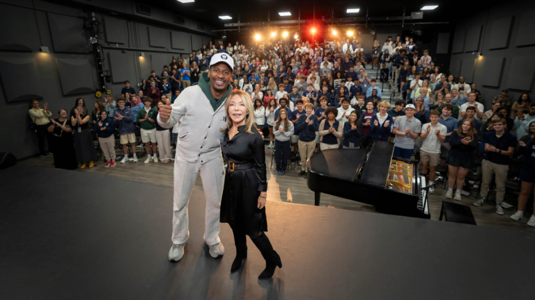 Jon Batiste and Paula Wallace at Columbus school with students.