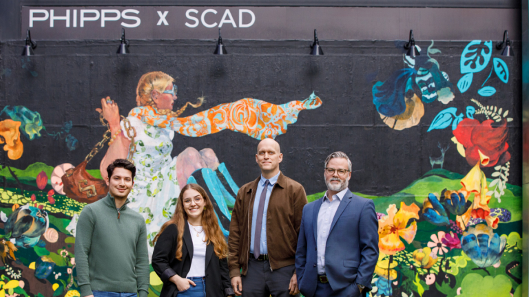 SCADpro students and faculty in front of Phipps Plaza mural