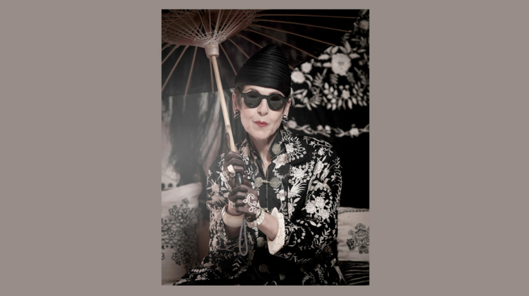 Black and white photo of style icon Tziporah Salamon with parasol