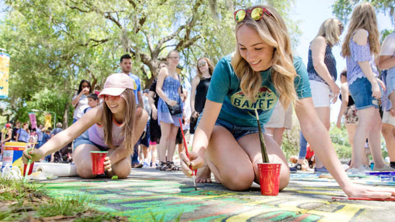 SCAD students painting with chalk at Sidewalk Arts Festival
