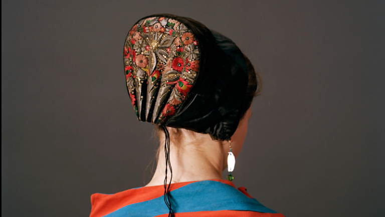Photograph of back of woman wearing danish bonnet
