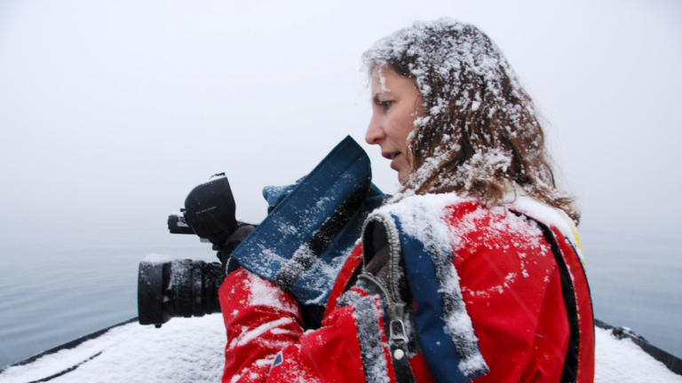 Janet Biggs in snow with camera