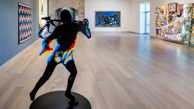 Fuzzy graphic outline of person standing actively within an art gallery