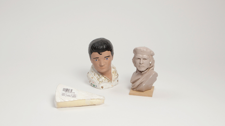 Miniature busts of Elvis Presley and Che Guevara with a slice of Brie